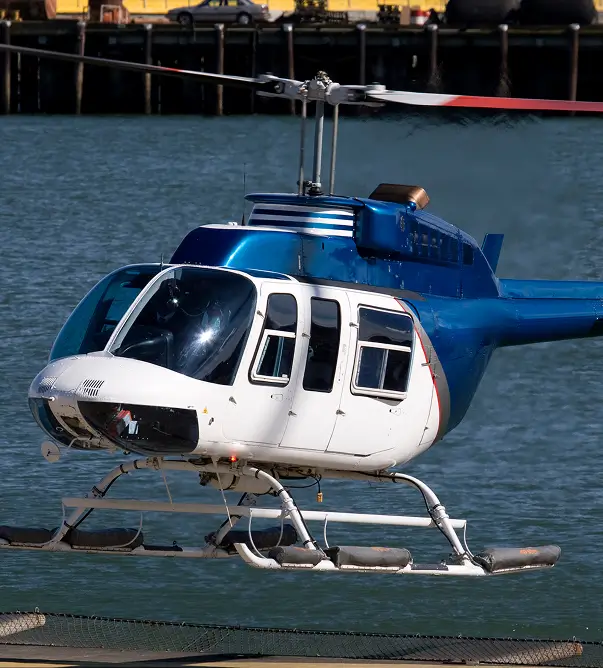 Blue helicopter over water